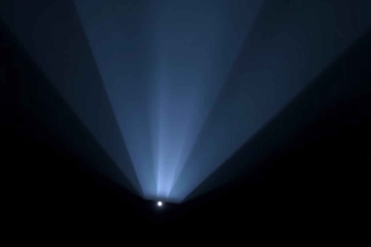 A beam of light rising through darkness